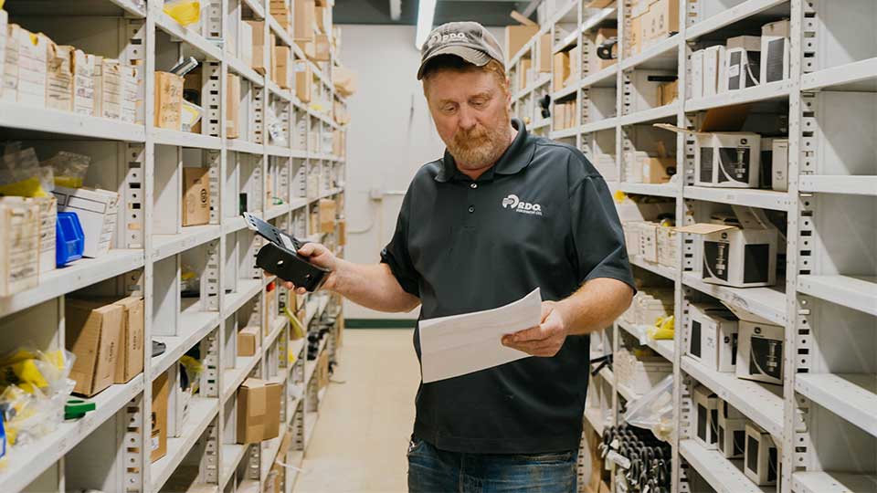Parts Specialist pulling parts off inventory shelf