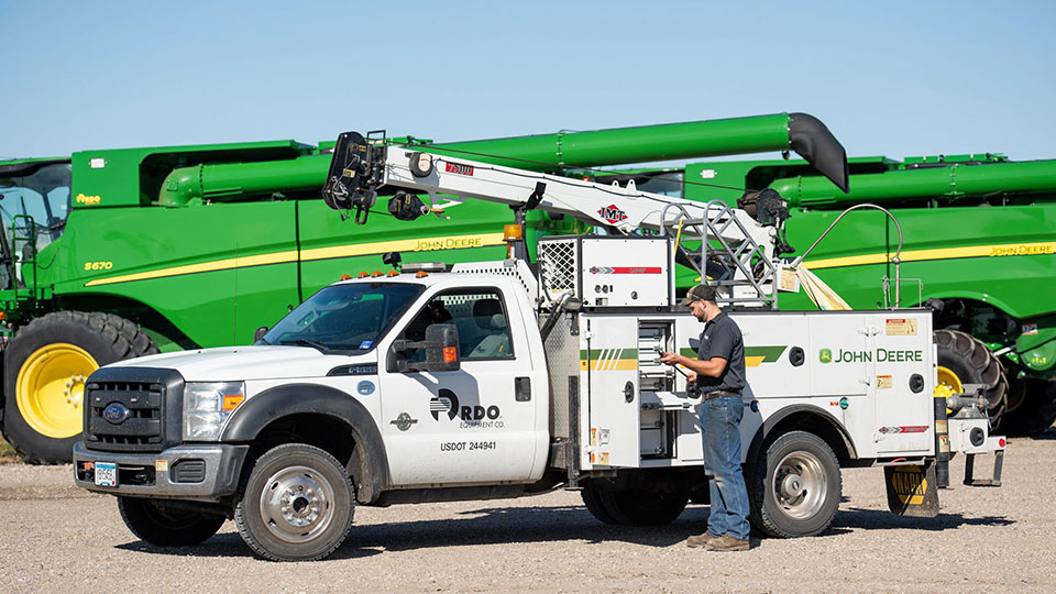 service truck in front of combines at farm