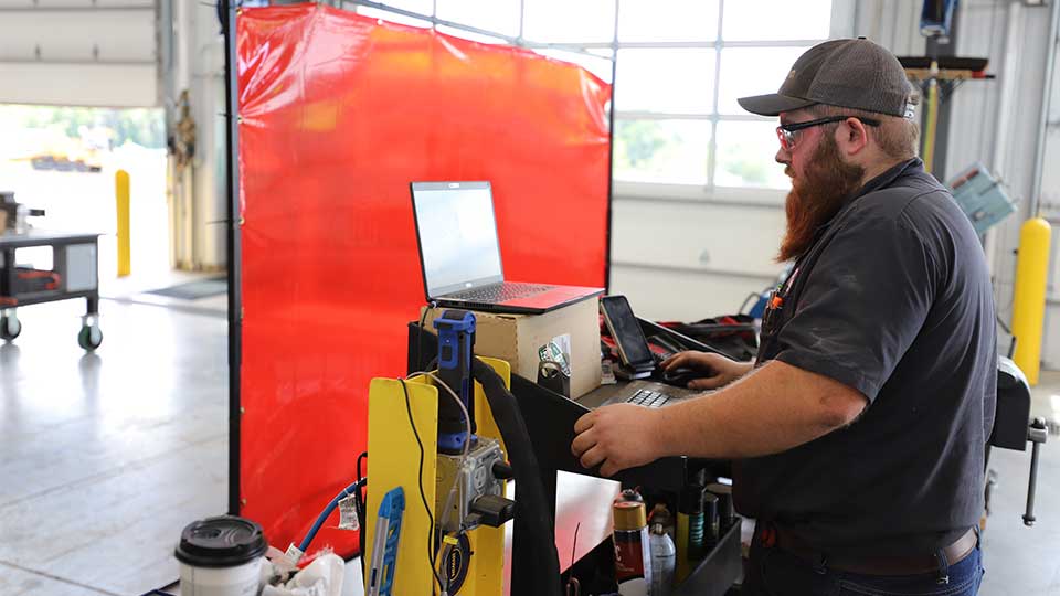 Diesel mechanic at tool station in dealership