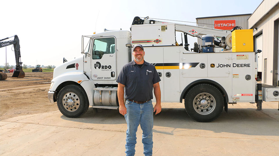 service technician in front of truck