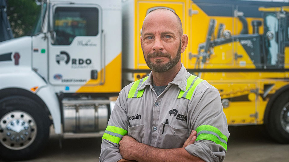 mobile mechanic in front of field truck