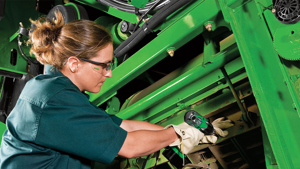 service technician working on tractor